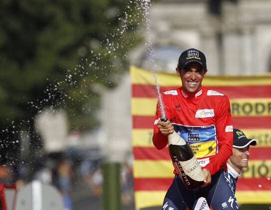 Team Saxo Bank rider Alberto Contador of Spain celebrates with a bottle of cava after winning the Tour of Spain after the last stage of the La Vuelta cycling race between Cercedilla and Madrid xALEJANDROxGONZALEZx 