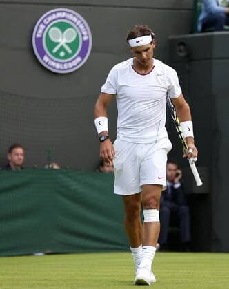 Rafael Nadal of Spain reacts during the first round of the men s singles at the Wimbledon Lawn Tennis Championships in the All England Lawn Tennis and Croquet Club in London, Britain, on June 24, 2013. (Xinhua Wang Lili) (SP)BRITAIN-LONDON-TENNIS-WIMBLEDON 