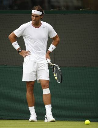 Rafael Nadal of Spain reacts during the first round of the men s singles at the Wimbledon Lawn Tennis Championships in the All England Lawn Tennis and Croquet Club in London, Britain, on June 24, 2013. (Xinhua Wang Lili) (SP)BRITAIN-LONDON-TENNIS-WIMBLEDON 
