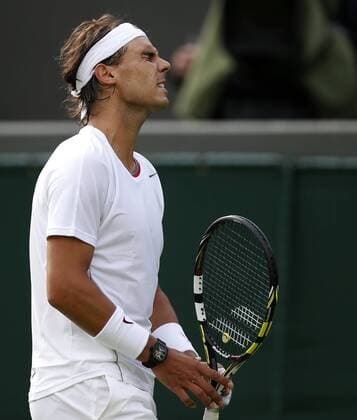 Rafael Nadal of Spain reacts during the first round of the men s singles at the Wimbledon Lawn Tennis Championships in the All England Lawn Tennis and Croquet Club in London, Britain, on June 24, 2013. (Xinhua Wang Lili) (SP)BRITAIN-LONDON-TENNIS-WIMBLEDON 