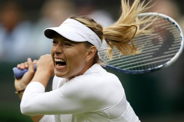 Maria Sharapova of Russia returns a shot during the first round of the women s singles at the Wimbledon Lawn Tennis Championships in the All England Lawn Tennis and Croquet Club in London, Britain, on June 24, 2013. (Xinhua Wang Lili) (SP)BRITAIN-LONDON-TENNIS-WIMBLEDON 