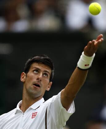 Novak Djokovic of Serbia serves during the first round of men s singles on day 2 of the Wimbledon Lawn Tennis Championships at the All England Lawn Tennis and Croquet Club in London, Britain, on June 25, 2013. 