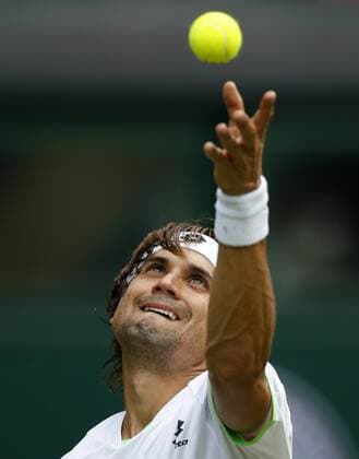 David Ferrer of Spain serves during the first round of men s singles on day 2 of the Wimbledon Lawn Tennis Championships at the All England Lawn Tennis and Croquet Club in London, Britain, on June 25, 2013. 