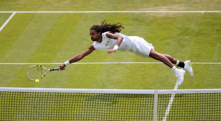 Germany s Dustin Brown dives in his match on day three of the 2013 Wimbledon Championships in London on June 26, 2013.  LON2013062602