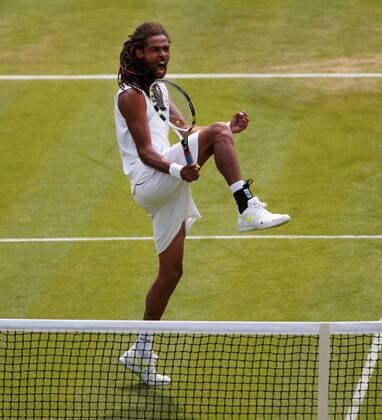 Germany s Dustin Brown celebrates winning the first set in his match on day three of the 2013 Wimbledon Championships in London on June 26, 2013.  LON2013062605