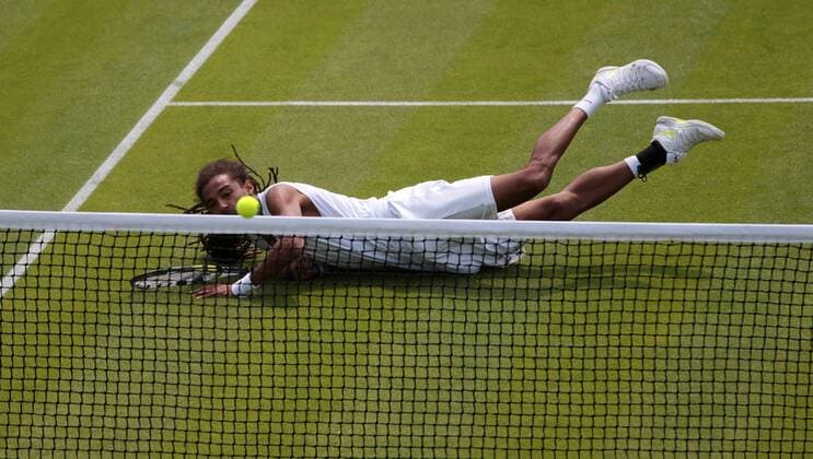 Germany s Dustin Brown dives in his match on day three of the 2013 Wimbledon Championships in London on June 26, 2013.  LON2013062603
