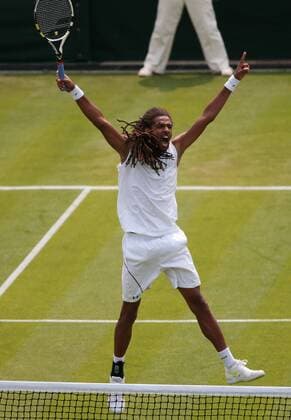 Germany s Dustin Brown celebrates winning the first set in his match on day three of the 2013 Wimbledon Championships in London on June 26, 2013.  LON2013062604