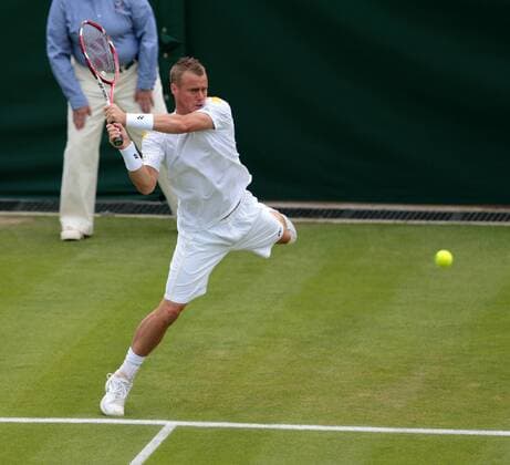 Australia s Lleyton Hewitt returns on day three of the 2013 Wimbledon Championships in London on June 26, 2013.  LON2013062606