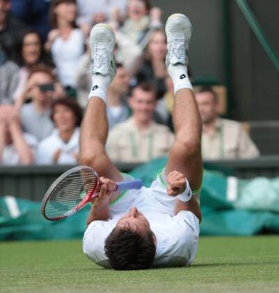 Ukranian Sergiy Stakhovsky celebrates on day three of the 2013 Wimbledon Championships in London on June 26, 2013.  LON2013062622