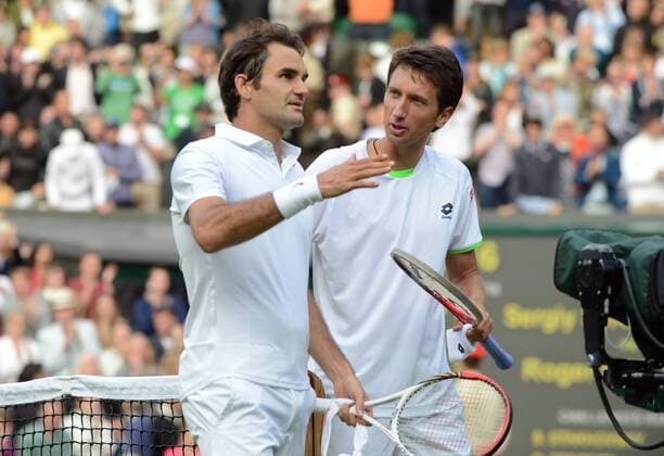 Tennis - 2013 Wimbledon Championships - Mens Singles second Round on Centre Court Roger Federer is consoled by Sergiy Stakhovsky after defeat 