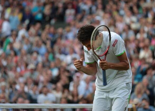 Ukranian Sergiy Stakhovsky celebrates his win over Roger Federer on day three of the 2013 Wimbledon Championships in London on June 26, 2013.  LON2013062624