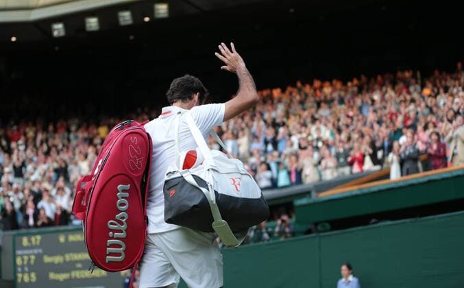 Roger Federer leaves Center Court after defeat to Sergiy Sakhovsky on day three of the 2013 Wimbledon Championships in London on June 26, 2013.  LON2013062628