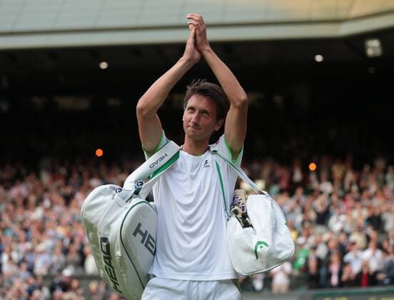 Ukranian Sergiy Stakhovsky celebrates his win over Roger Federer on day three of the 2013 Wimbledon Championships in London on June 26, 2013.  LON2013062629