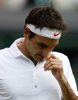 Roger Federer of Switzerland reacts during the second round of men s singles on day 3 of the Wimbledon Lawn Tennis Championships at the All England Lawn Tennis and Croquet Club in London, Britain, on June 26, 2013. (Xinhua Wang Lili) (SP)BRITAIN-LONDON-TENNIS-WIMBLEDON-DAY 3 