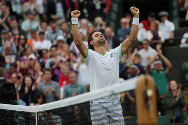 Spain s David Ferrer celebrates his victory on day five of the 2013 Wimbledon Championships in London on June 28, 2013.  LON2013062816