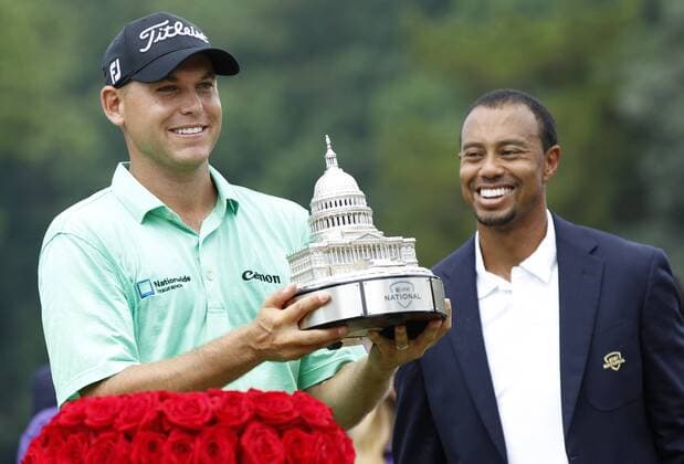 Bill Haas holds his trophy next to Tiger Woods after winning the AT&T National at Congressional Country Club on June 30, 2013 in Bethesda, Maryland.  WAP20130630837