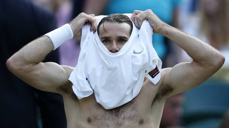 Tommy Haas of Germany changes his jersey during a break of the fourth round of men s singles on day 7 of the Wimbledon Lawn Tennis Championships at the All England Lawn Tennis and Croquet Club in London, Britain on July 1, 2013. (Xinhua Wang Lili) (SP)BRITAIN-LONDON-TENNIS-WIMBLEDON-DAY 7 