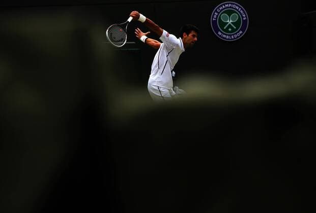 (130703) -- LONDON, July 3, 2013 (Xinhua) -- Novak Djokovic of Serbia hits a return during the quarterfinal of men s singles on day 9 of the Wimbledon Lawn Tennis Championships at the All England Lawn Tennis and Croquet Club in London, Britain, on July 3, 2013. (Xinhua Yin Gang) (jyc) (SP)BRITAIN-LONDON-TENNIS-WIMBLEDON-DAY 9 
