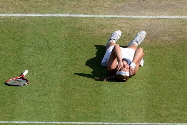 Tennis - 2013 Wimbledon Championships - Ladies Semi Final Sabine Lisicki - Germany drops the the ground after winning her Semi Final 