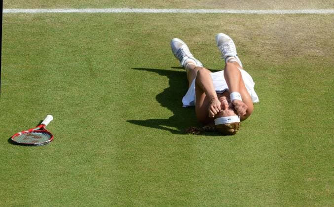 Tennis - 2013 Wimbledon Championships - Ladies Semi Final Sabine Lisicki - Germany drops the the ground after winning her Semi Final 