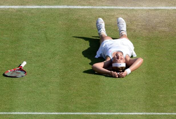 Tennis - 2013 Wimbledon Championships - Ladies Semi Final Sabine Lisicki - Germany drops the the ground after winning her Semi Final 