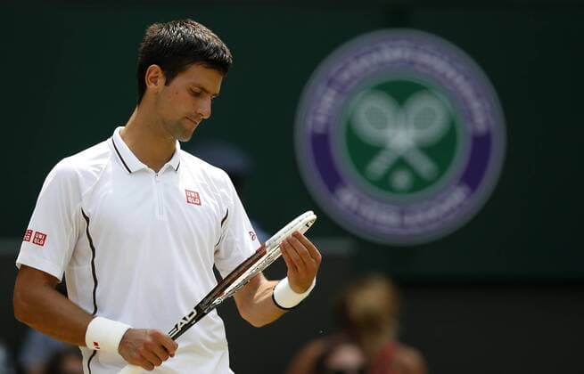 (130705) -- LONDON, July 5, 2013 (Xinhua) -- Novak Djokovic of Serbia reacts during the semifinal of gentlemen s singles on day 11 of the Wimbledon Lawn Tennis Championships at the All England Lawn Tennis and Croquet Club in London, Britain on July 5, 2013. (Xinhua Wang Lili) (SP)BRITAIN-LONDON-TENNIS-WIMBLEDON-DAY 11 