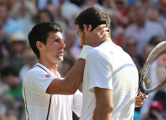 Novak Djokovic consoles Juan Martin Del Potro after his semifinal win at the Wimbledon Tennis Championships in London, Friday, 5th July 2013 Picture by StephenxLock i-Images StephenxLockx xi-Images  IIM-0185-0059
