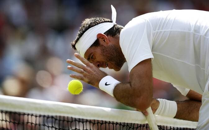 Juan Martin Del Potro of Argentina puts the ball which he missed to the other side of the net during the semifinal of gentlemen s singles on day 11 of the Wimbledon Lawn Tennis Championships at the All England Lawn Tennis and Croquet Club in London, Britain on July 5, 2013. (Xinhua Wang Lili) (SP)BRITAIN-LONDON-TENNIS-WIMBLEDON-DAY 11 