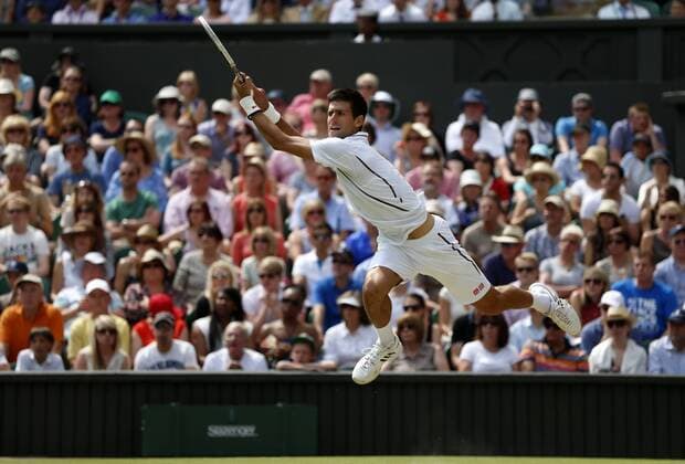 Novak Djokovic of Serbia returns the ball during the semifinal of men s singles on day 11 of the Wimbledon Lawn Tennis Championships at the All England Lawn Tennis and Croquet Club in London, Britain on July 5, 2013. (Xinhua Wang Lili) (SP)BRITAIN-LONDON-TENNIS-WIMBLEDON-DAY 11 