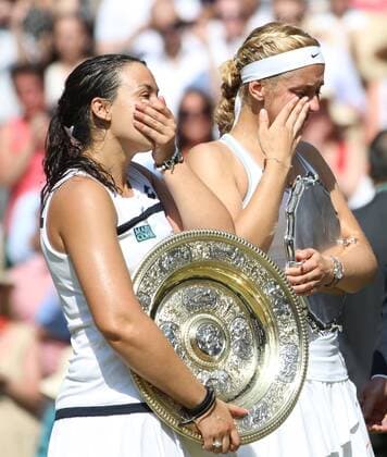 Marion Bartoli and Sabine Lisicki hold their trophies at the winners ceremony of the Women s Final of the 2013 Wimbledon Championships in London on July 6, 2013.  LON2013070619