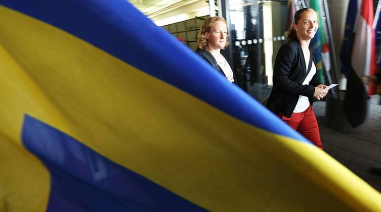 FRANKFURT AM MAIN, GERMANY - JULY 07: Team mates of Germany pass a flag of Sweden during the Germany women s national team departure to Sweden at Frankfurt Airport on July 7, 2013 in Frankfurt am Main, Germany.