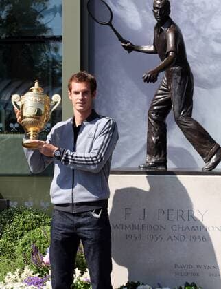 Andy Murray of Great Britain poses with the Gentlemen s Singles Trophy next to the Fred Perry statue at Wimbledon London, United Kingdom, Monday July 08, 2013. Photo by: Roger Allen i-Images RogerxAllenx xi-Images  SLK