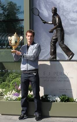 Andy Murray of Great Britain poses with the Gentlemen s Singles Trophy next to the Fred Perry statue at Wimbledon London, United Kingdom, Monday July 08, 2013. Photo by: Roger Allen i-Images RogerxAllenx xi-Images  SLK