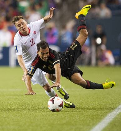 July 11, 2013 - Seattle, Washington, US - Mexico s Adrian Aldrete (13) and Canada s Nikolas Ledgerwood (2) battle for the ball. Held every two years, the CONCACAF Gold Cup is the main association football competition of the men s national football teams governed by CONCACAF, determining the regional champion of North America, Central America, and the Caribbean. Soccer 2013 - CONCACAF Gold Cup - Mexico beats Canada 2-0 - ZUMAkh1
