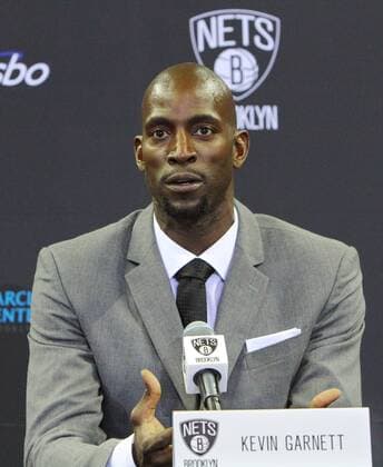 Brooklyn Nets new team member Kevin Garnett answers a reporter s question as he along with Paul Pierce and Jason Terry are introduced during a press conference held at the Barclays Center in the borough of Brooklyn on July 18, 2013 in New York.  NYP20130718304