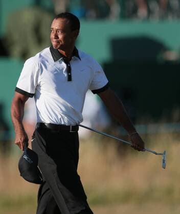 USA s Tiger Woods raises his hat at the 18th green on the first day of the 2013 Open Championship in Muirfield, Scotland on July 18 , 2013.  LON2013071841