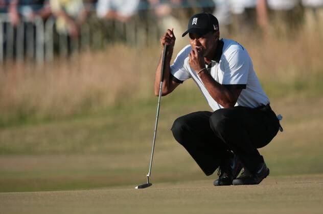 USA s Tiger Woods lines up his putt on the 18th green on the first day of the 2013 Open Championship in Muirfield, Scotland on July 18 , 2013.  LON2013071844