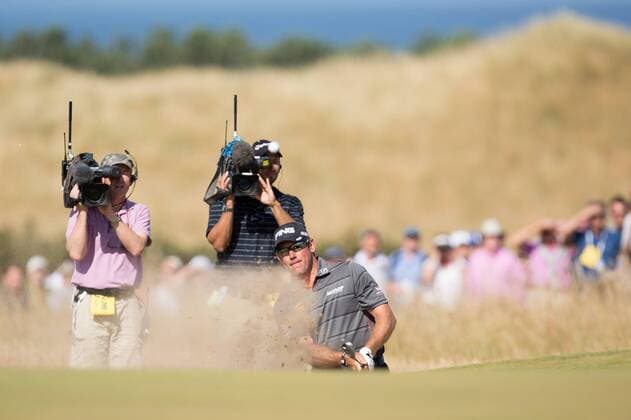 Golf - 2013 Open Championship at Muirfield - Friday Round Two Lee Westwood of England gets himself out of a bunker on the approach to the 5th green 