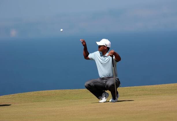 USA s Tiger Woods catches a ball on the 11th green on the second day of the 2013 Open Championship in Muirfield, Scotland on July 19 , 2013.  LON2013071928