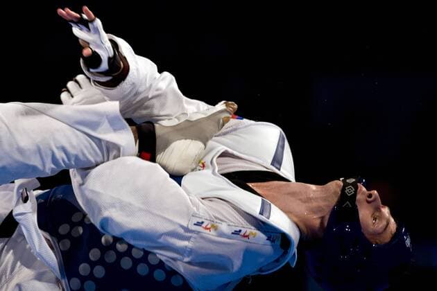 Marc Andre Bergeron of Canada combats against Rafael Castillo of Cuba, in the 87kg male quarterfinals of the Taekwondo World Championship of the World Taekwondo Federation (WTF), at the Expositions and Coventions Center of Puebla, in Puebla, Mexico, on July 19, 2013. (Xinhua Guillermo Arias) (rt) (SP)MEXICO-PUEBLA-TAEKWONDO-WORLD CHAMPIONSHIP 