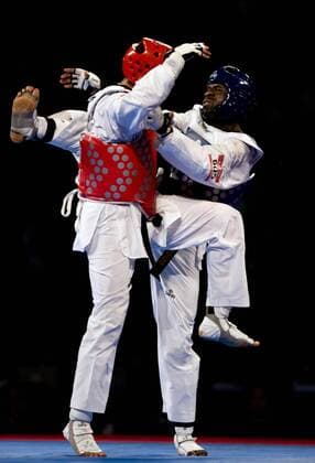 Anthony Obame (R) of Gabon, combats against Sajjad Mardani (L) of Iran, in the 87kg male finals of the Taekwondo World Championship of the World Taekwondo Federation (WTF), at the Expositions and Coventions Center of Puebla, in Puebla, Mexico, on July 19, 2013. (Xinhua Guillermo Arias) (py) (SP)MEXICO-PUEBLA-TAEKWONDO-WORLD CHAMPIONSHIP 