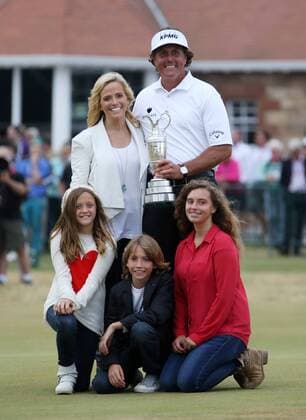 USA s Phil Mickelson holds the Claret Jug with his family, wife Amy, and the children Amanda Brynn, Sophia Isabel and Evan Samuel beside him after winning the Open Championship at Muirfield on the fourth day of the 2013 Open Championship in Muirfield, Scotland on July 21 , 2013.Mickelson won with a score of three under par.  LON2013072104