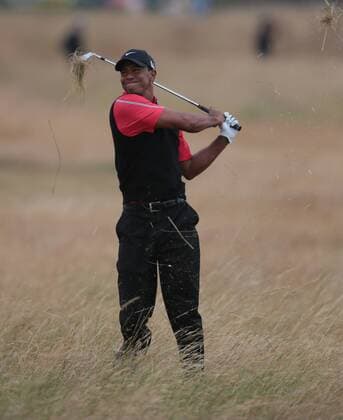 USA s Tiger Woods hits out of the rough on the eleventh hole on the fourth day of the 2013 Open Championship in Muirfield, Scotland on July 21 , 2013.Phil Mickelson won the championship with a score of three under par.  LON2013072109