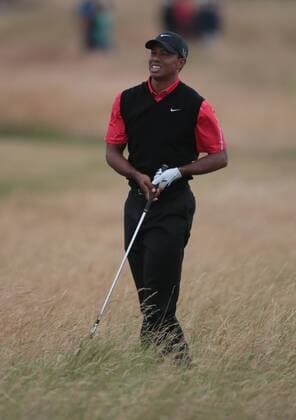 USA s Tiger Woods shows emotion in the rough on the eleventh hole on the fourth day of the 2013 Open Championship in Muirfield, Scotland on July 21 , 2013.Phil Mickelson won the championship with a score of three under par.  LON2013072110