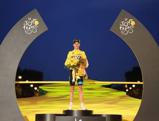 Chris Froome of Great Britain arrives on the presentation podium after winning the Tour de France in Paris on July 21, 2013. Froome became Britain s second consecutive Tour winner after Bradley Wiggins won the event last year.  PAR20130721706