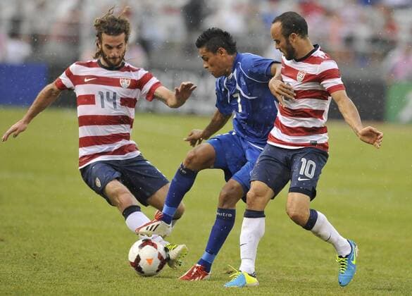 July 21, 2013 - Baltimore, MD, USA - U.S. s Kyle Beckerman gets a foot on the ball as El Salvador s Darwin Ceren Delgado holds off U.S. s Landon Donovan during the second half of the Gold Cup quarterfinals in Baltimore, Maryland, Sunday, July 21, 2013. U.S. wins, 5-1. El Salvador vs. USA - ZUMAm67