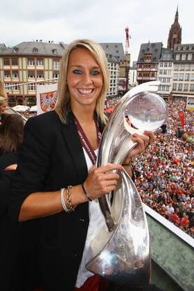 FRANKFURT AM MAIN, GERMANY - JULY 29: Lena Goessling of Germany lifts the trophy of the UEFA Women s EURO 2013 on the balcony of the Römer on July 29, 2013 in Frankfurt am Main, Germany. Local Caption Lena Goessling