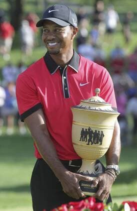 Aug. 4, 2013 - Akron, OH, USA - Tiger Woods clutches the Gary Player Cup after capturing his eighth win of the World Golf Championships Bridgestone Invitational at Firestone Country Club in Akron, Ohio, Sunday, August 4, 2013. Bridgestone Invitational final round - ZUMAm67