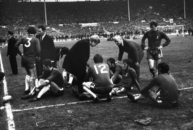 Football - 1970 FA Cup Final - First Game Chelsea 2 Leeds United 2 Chelsea players prepare for extra time as manager Dave Sexton talks to Eddie McCreadie ( 3), and trainer Ron Stuart and Alan Birchenall talk to Ian Hutchinson, John Dempsey and Tommy Baldwin ( 12), Peter Houseman, right. 11 04 1970 