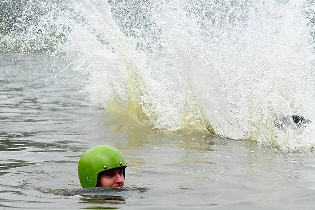 ITAR-TASS: IVANOVO, RUSSIA. AUGUST 5, 2013. Competitors jump into the water off a ramp in Fun Jumping, a bike jumping event in the city of Ivanovo.  RE1245F6